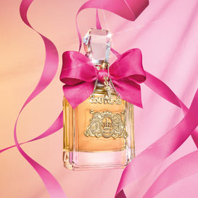 Model spraying Juicy Couture pen offering quick on-the-go fragrance refresh