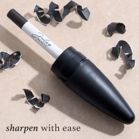 Julep pencil beside coin for scale to show compact, travel-friendly size