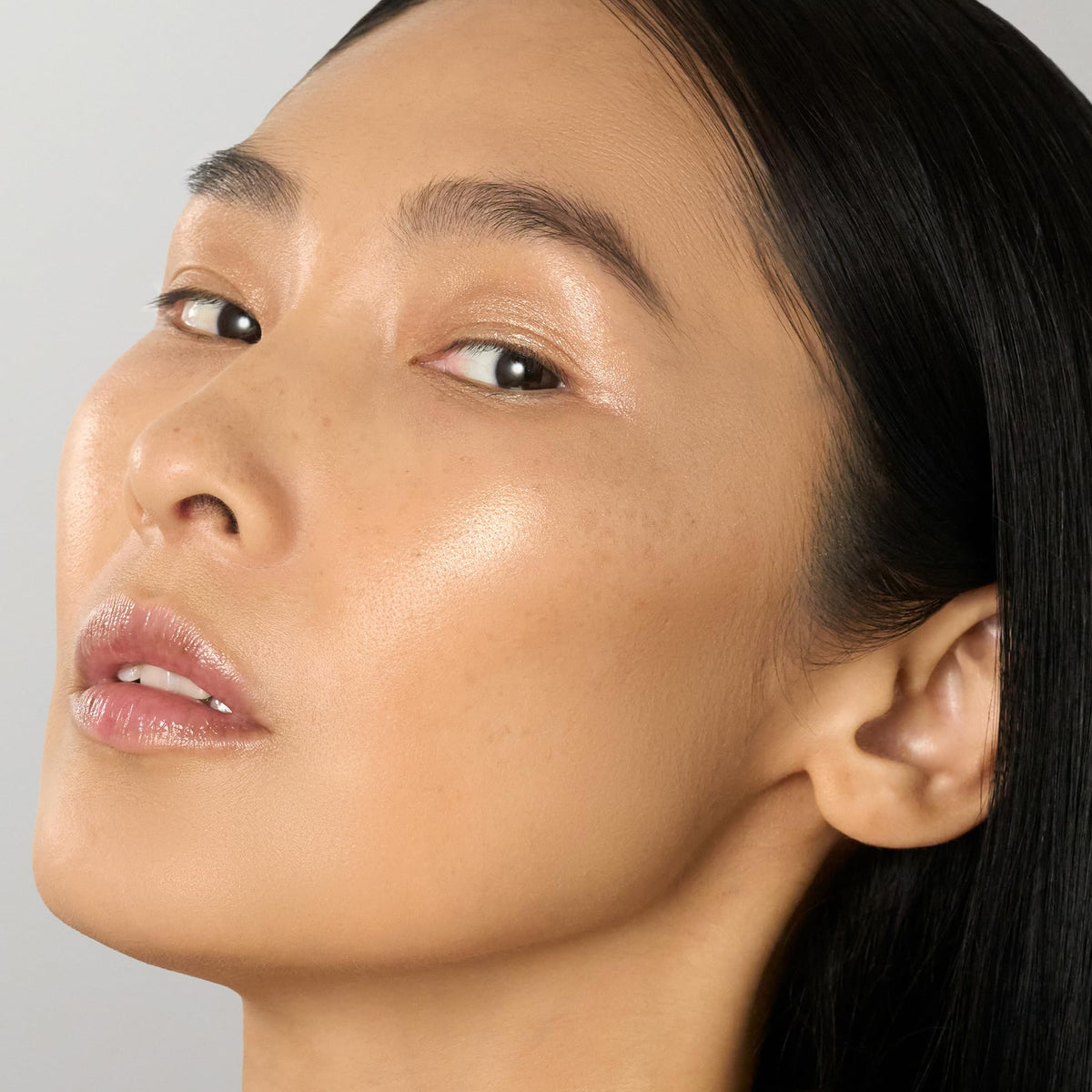 Julep highlighter swipe on cheekbone demonstrating natural dewy radiance