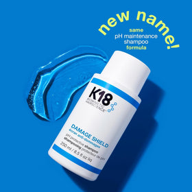 K18 bottle held in hand showing scale and travel-friendly 16 fl oz benefit