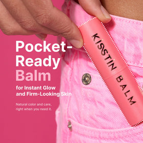 KAHI Kisstin Balm in hand to show 0.32 oz size and travel convenience