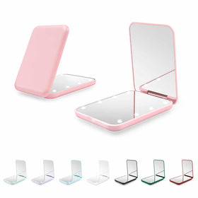 Kakuje compact mirror front view showing pink finish and LED lights, great for travel