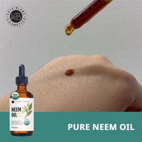 Kate Blanc neem oil pouring into spoon to show thick texture and control for DIY blends