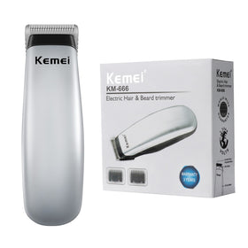 KEMEI clippers held in hand to show pocket-sized scale and easy one-handed use