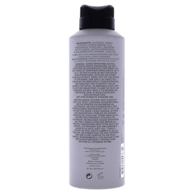 Man spraying Kenneth Cole Reaction on chest before going out, illustrating quick refresh and energetic scent