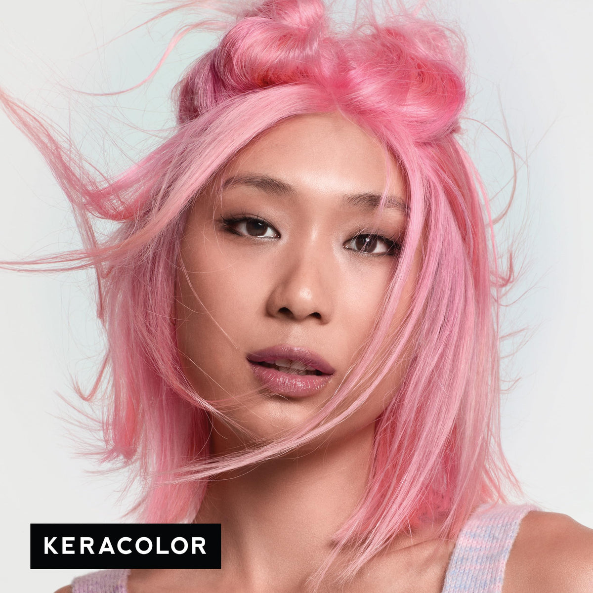 KERACOLOR applying LIGHT PINK clenditioner to hair demonstrating even color deposit