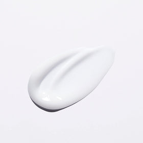KÉRASTASE bottle in bathroom setting suggesting everyday salon-grade routine