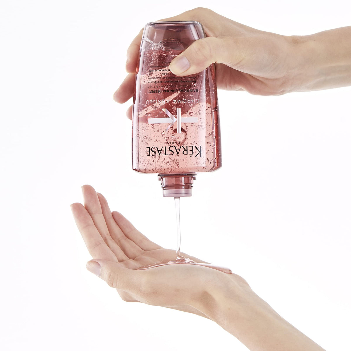 KÉRASTASE bottle next to ruler demonstrating 8.5 fl oz size and travel-friendly benefit