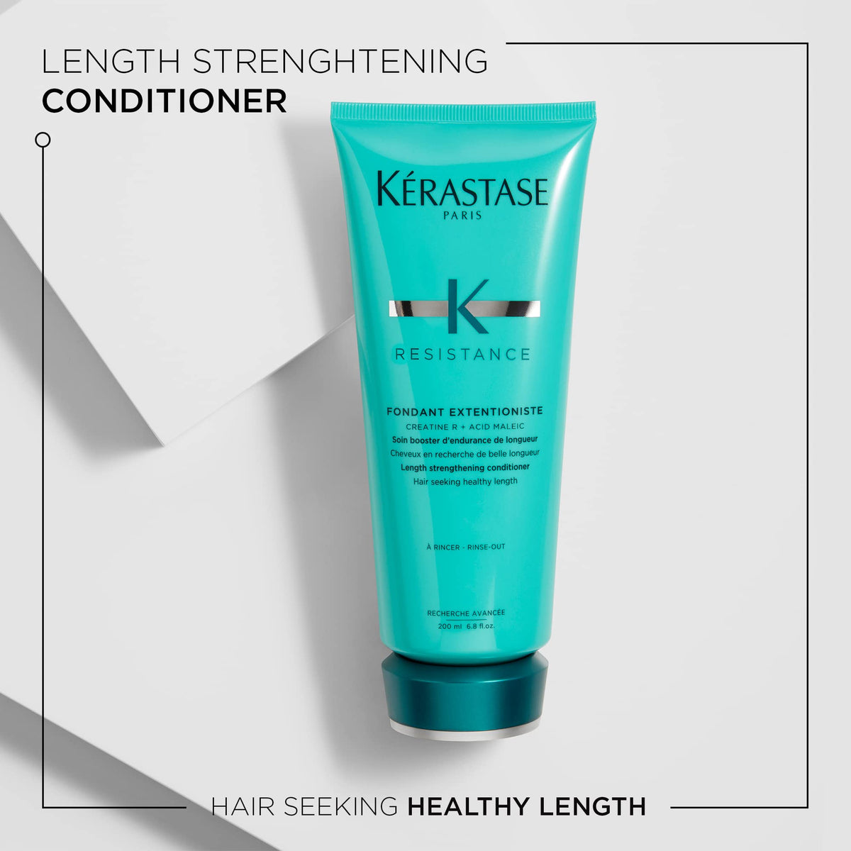 KÉRASTASE creamy conditioner texture on fingers, demonstrating nourishing, non-greasy formula