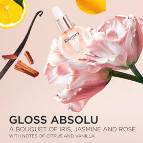 KÉRASTASE bottle beside hand showing compact size and travel-friendly benefit