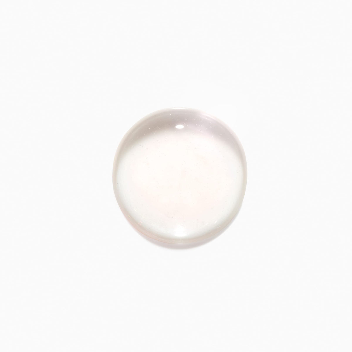 KÉRASTASE applied to scalp by hand demonstrating even distribution and absorption