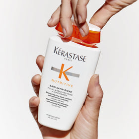 KÉRASTASE bottle on bathroom shelf showing lifestyle-ready haircare solution