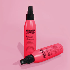 Keratin Complex bottle next to hand for scale and travel-friendly 5 fl oz benefit
