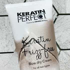 Keratin Perfect tube beside passport showing travel-friendly 2.5oz size for on-the-go convenience