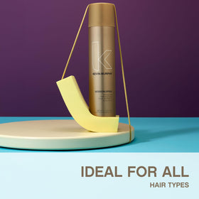 KEVIN.MURPHY bottle in a hand to show scale and portable 3.4 fl oz convenience for on-the-go touch-ups