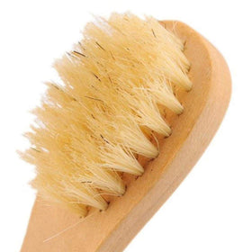 KEWLYSEU brush held in hand to show scale and precise control for targeted facial cleansing