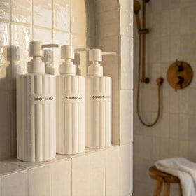 KIBAGA front view set of three beige bottles showing organized look and easy access