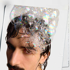 Kiehl's shampoo pouring into hand highlighting texture and spreadability