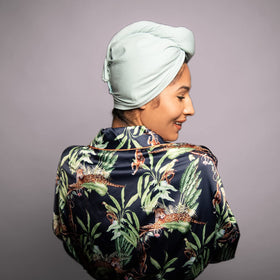 KISMETICS care label inside turban showing fabric info and long-lasting use benefit