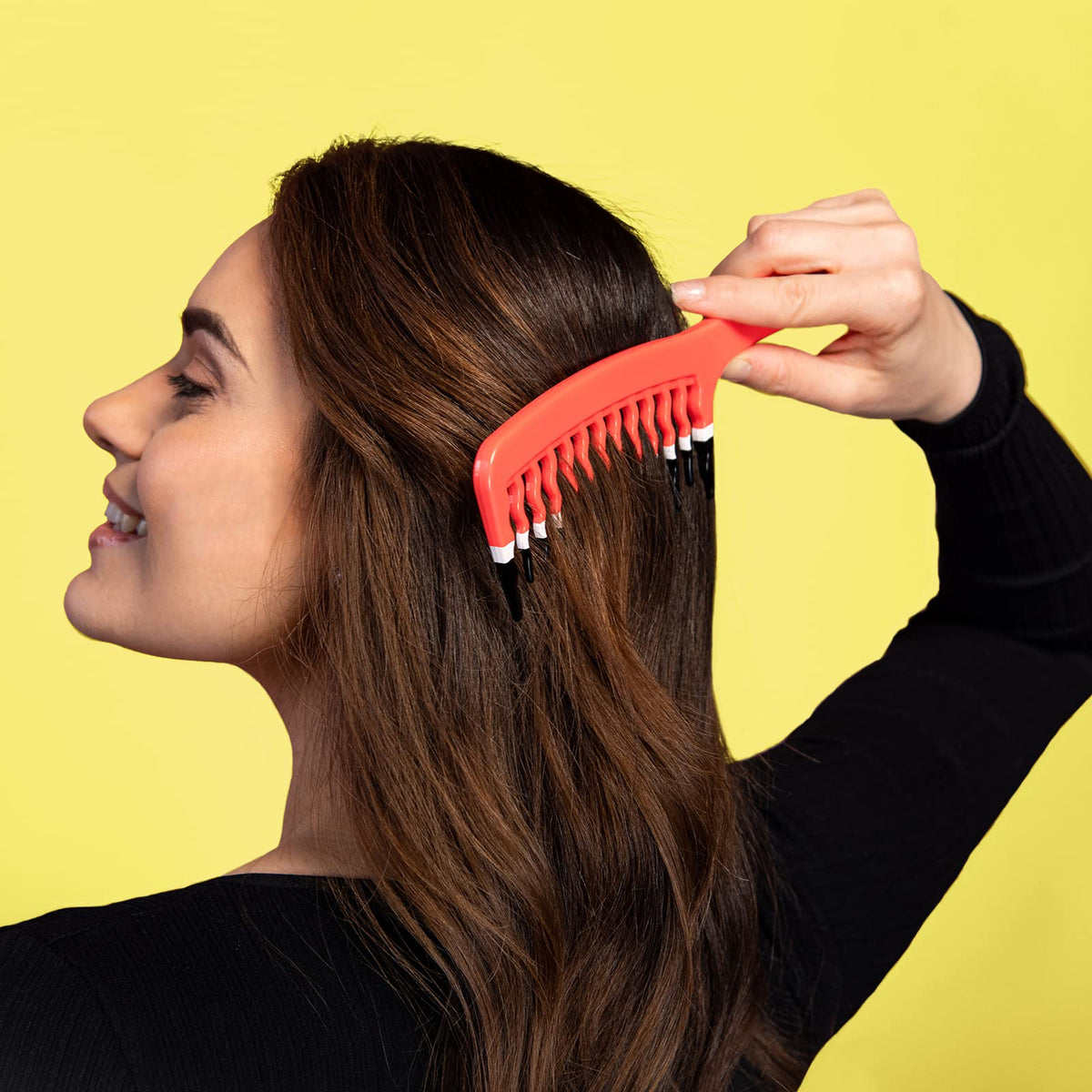KISMETICS comb held in hand to show extra-large scale for faster detangling