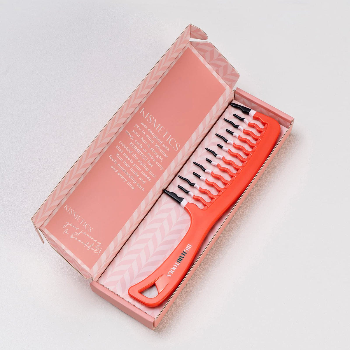 KISMETICS comb sliding through curly hair to define curls and reduce frizz