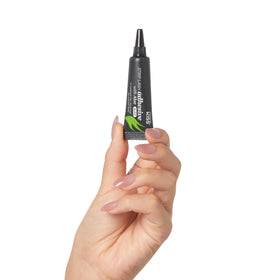 KISS adhesive being applied to strip eyelash demonstrating quick tack application