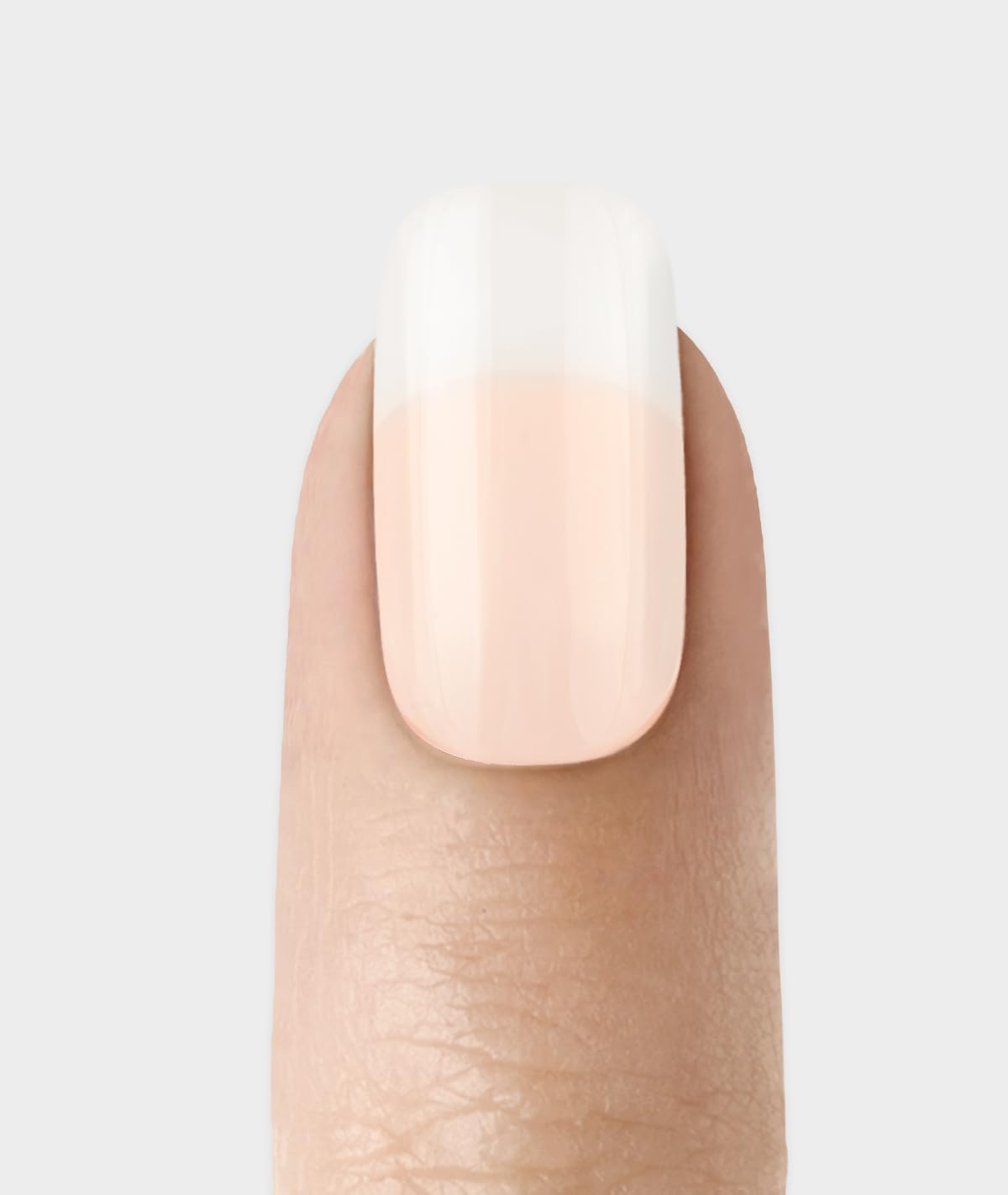KISS applied on hand in lifestyle scene, shows durable salon-like French manicure benefit