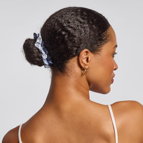 Kitsch scrunchie on pillow in sleep setting helping reduce morning creases