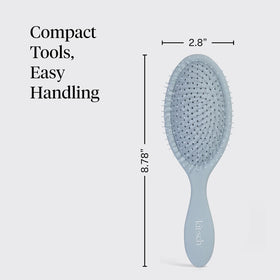 Kitsch brush shown in hand for scale, compact and travel-friendly benefit
