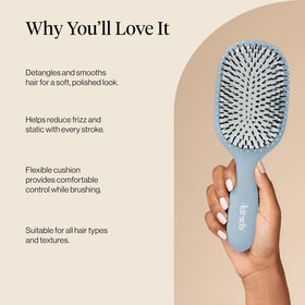 Kitsch brush held in hand to show compact size and travel-friendly portability