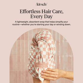 Kitsch towel draped on bathroom vanity as stylish, practical hair accessory