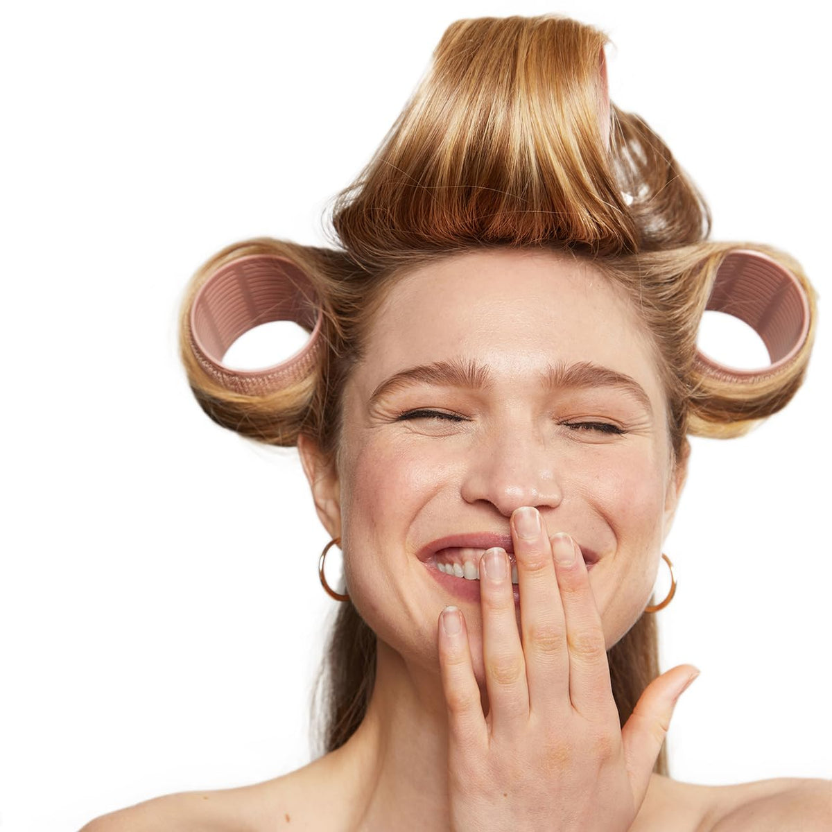 Kitsch rollers on bedside table illustrating convenient overnight styling benefit