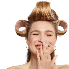 Kitsch rollers on bedside table illustrating convenient overnight styling benefit