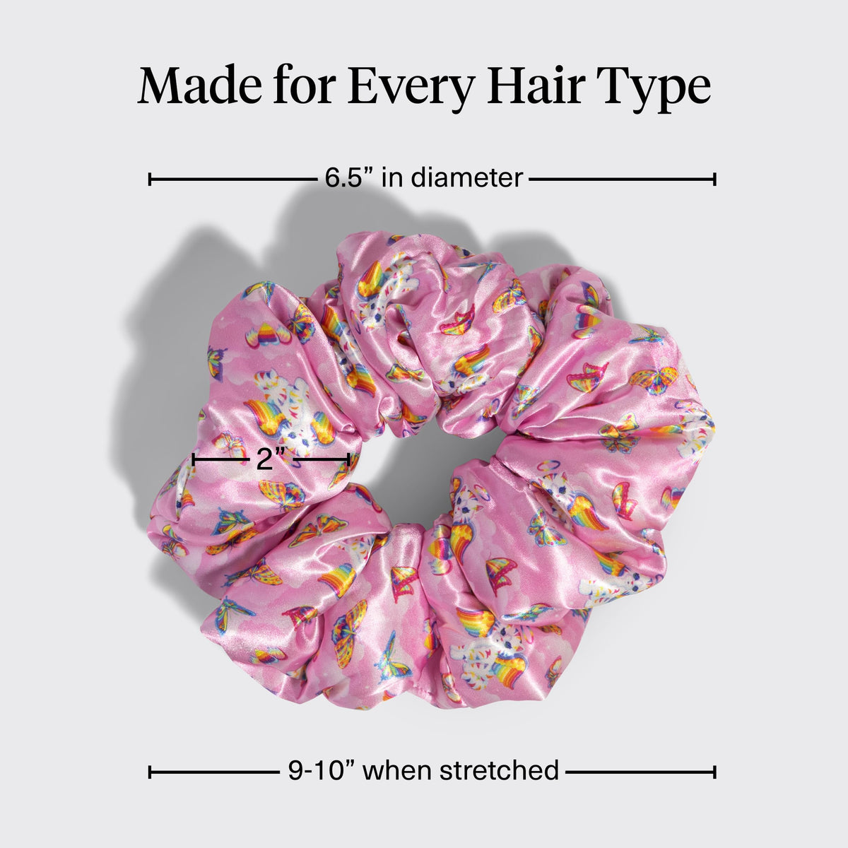 Kitsch Lisa Frank scrunchies held in hand to show size and comfortable scale
