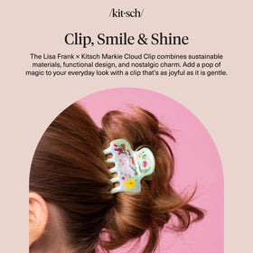 Kitsch Markie clip next to a hand for size comparison showing portable, lightweight benefit
