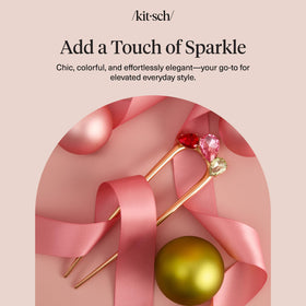 Kitsch pin resting on a clutch demonstrating easy on-the-go styling