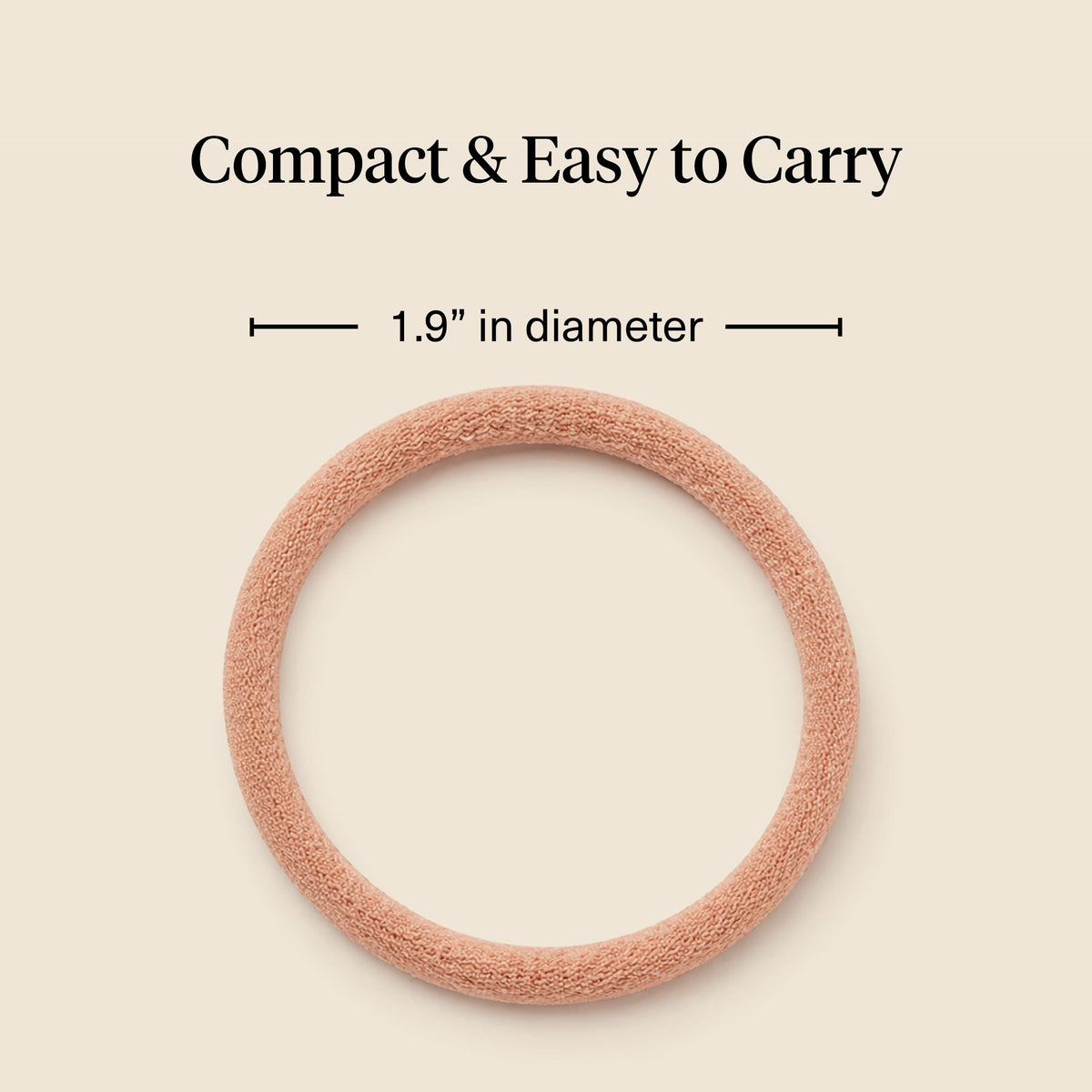 Kitsch hand holding hair tie to show scale and easy-carry convenience benefit