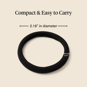 Kitsch hair tie held in hand for size and stretch comparison benefit