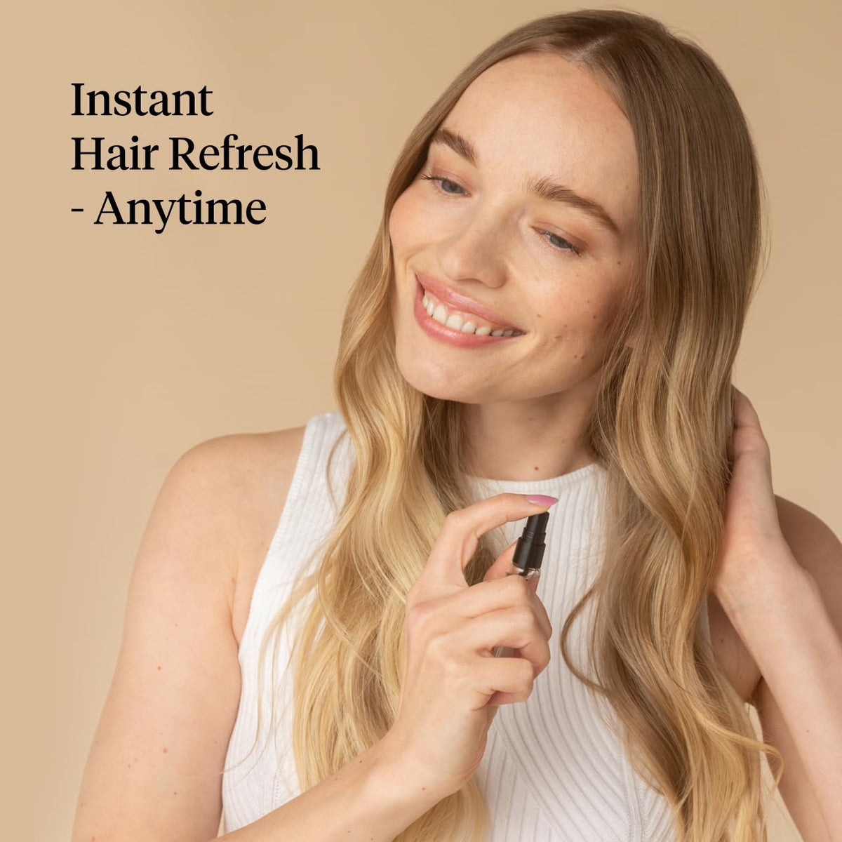 Kitsch mini sprays in a hand showing compact pocket-size convenience
