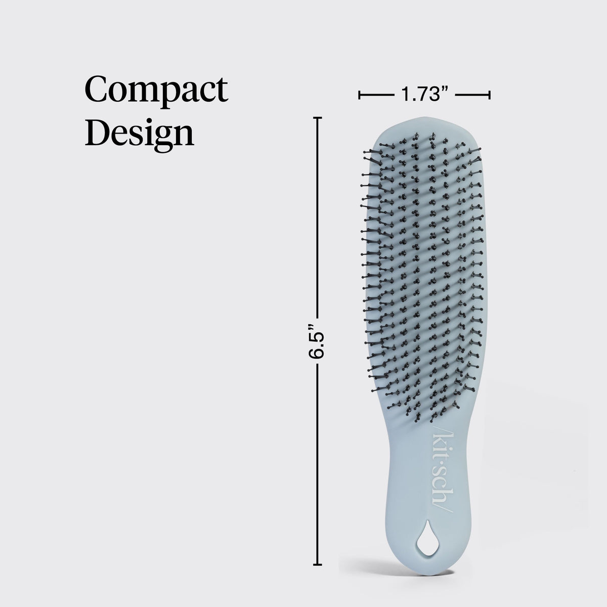 Kitsch brush next to hand to show compact size and easy maneuverability