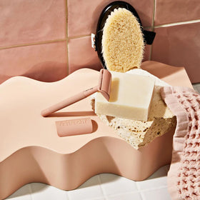 Kitsch shaving bar in travel kit flatlay conveying spill-free convenience