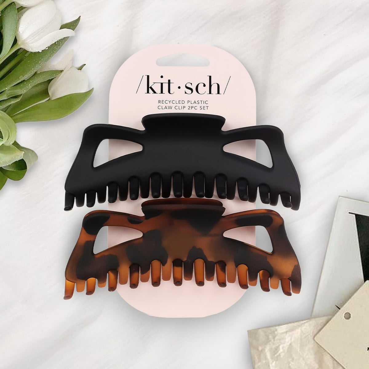 Kitsch clip beside a hand to show 5-inch size and easy handling