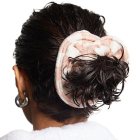 Kitsch scrunchie placed beside a hand for scale, shows large size for thick hair