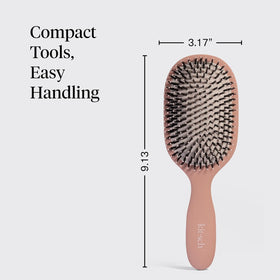 Kitsch brush held in hand for size comparison and easy-use benefit