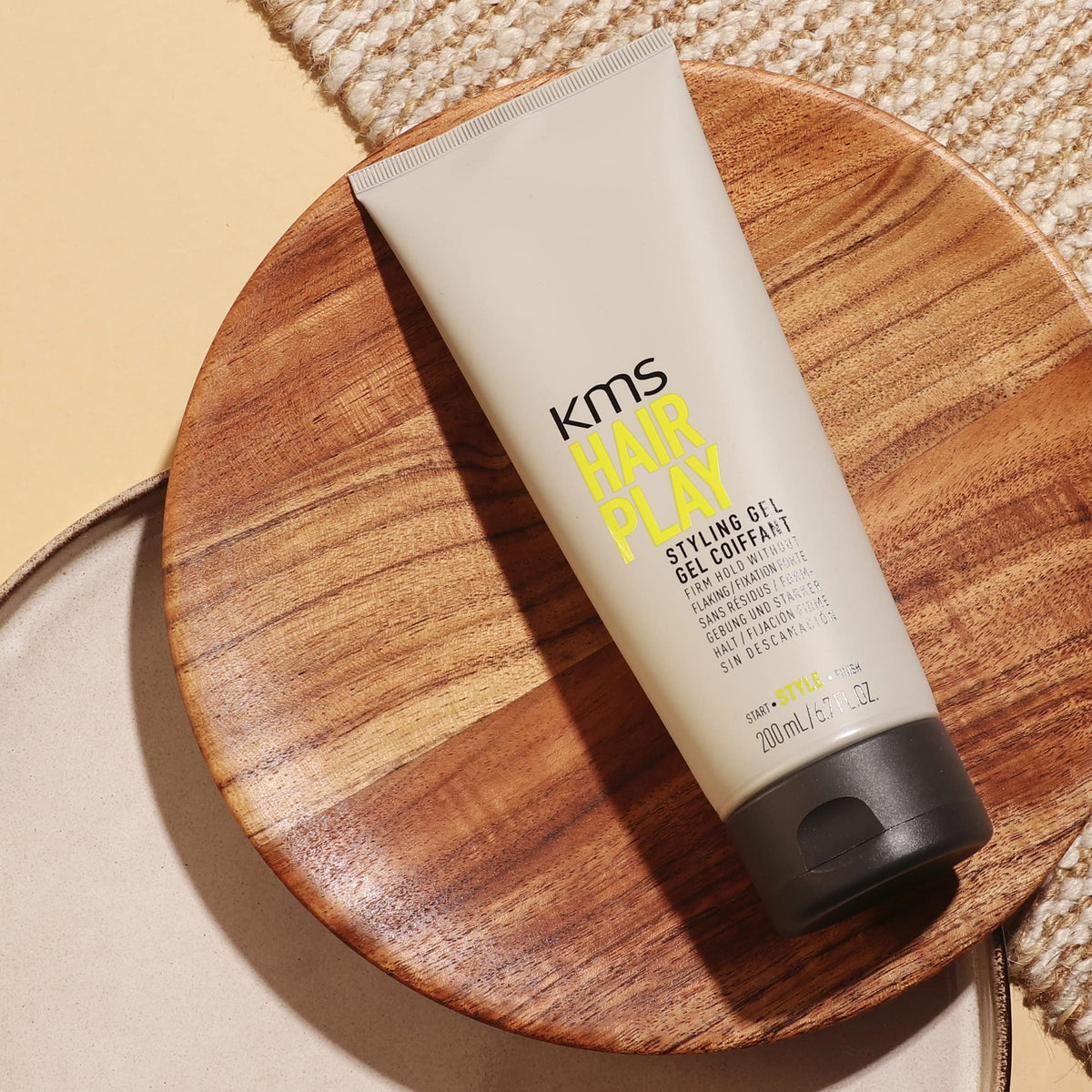 KMS HairPlay next to everyday items illustrating compact 200ml size
