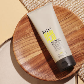 KMS HairPlay next to everyday items illustrating compact 200ml size