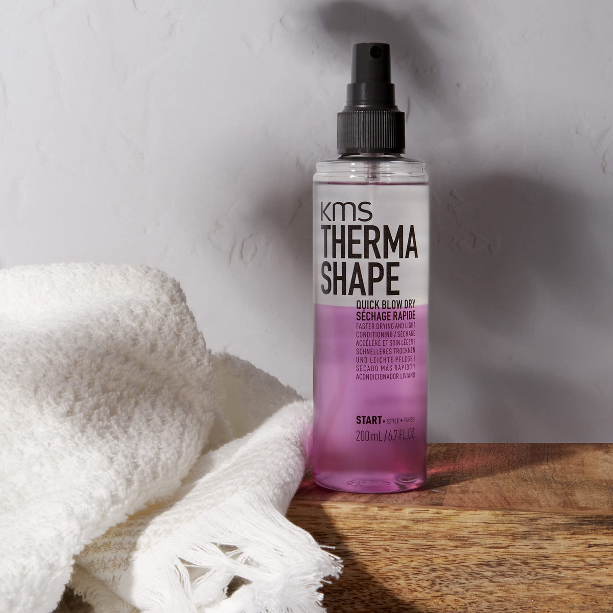 KMS ThermaShape spray mist on towel-damp hair for faster drying and smoother styling