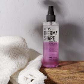 KMS ThermaShape spray mist on towel-damp hair for faster drying and smoother styling