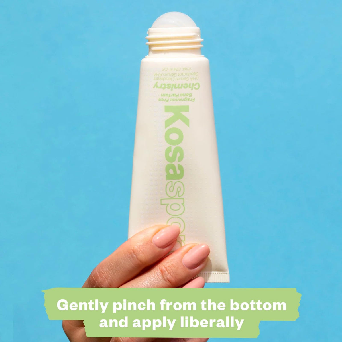 Kosas bottle next to everyday items to show travel-friendly size