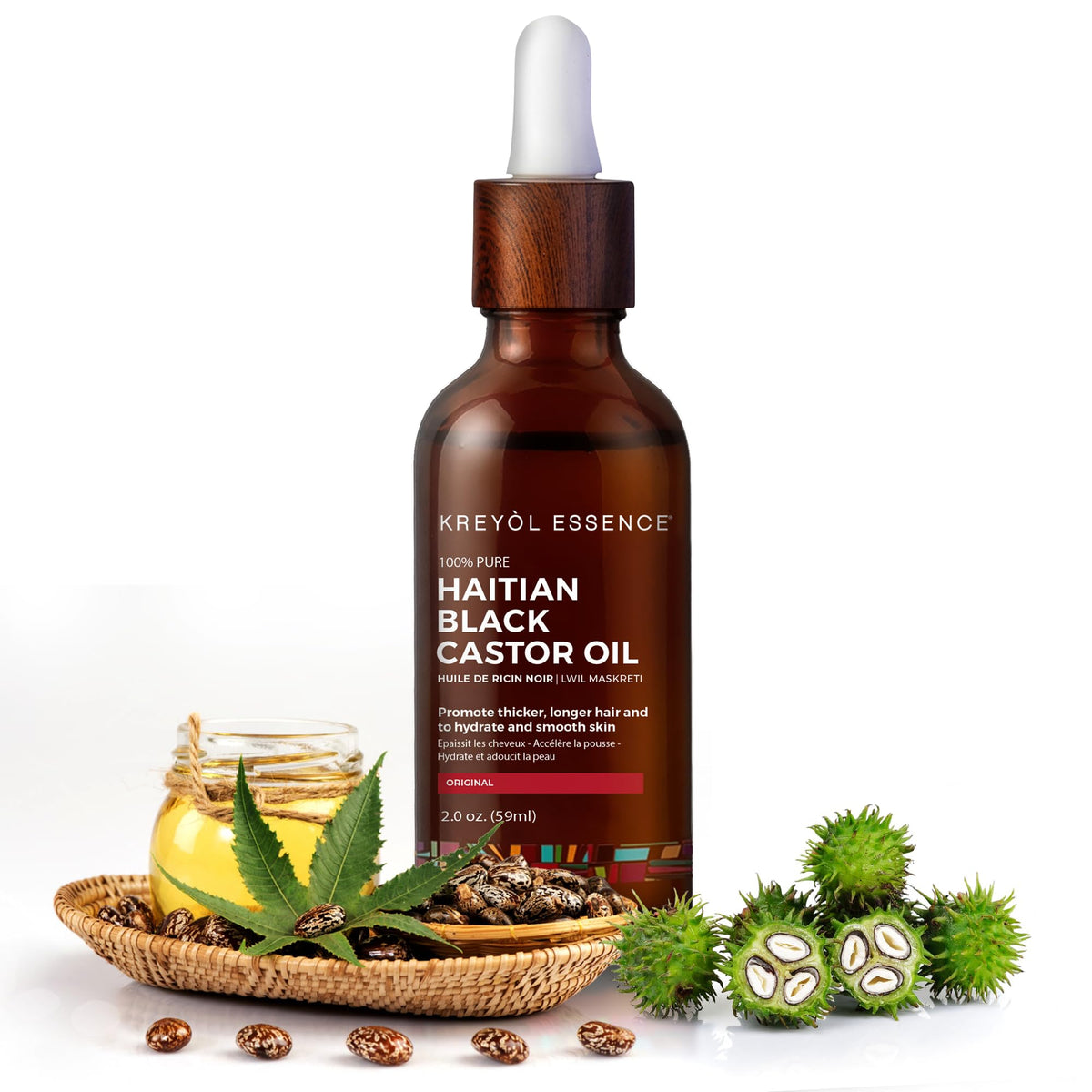 KREYÒL ESSENCE castor oil pouring from dropper demonstrating rich texture and coverage